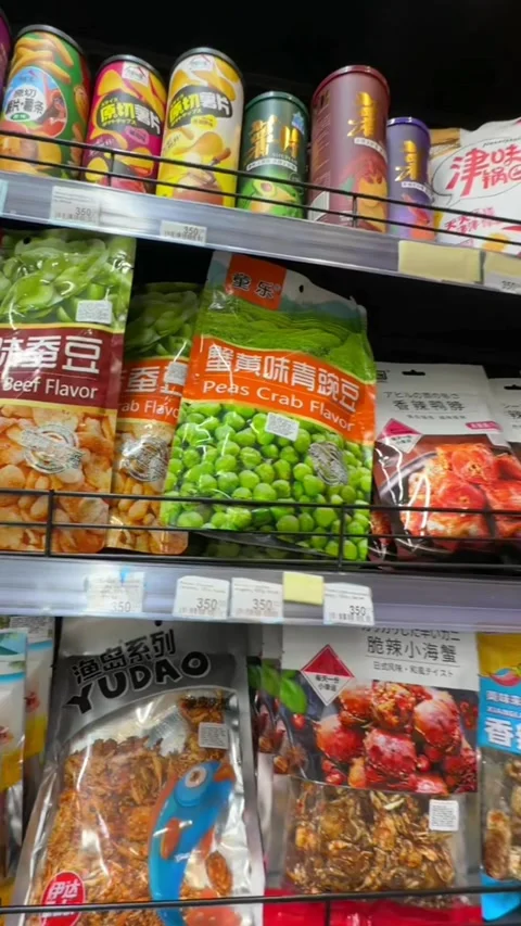 Assorted snack food packages displayed on supermarket retail shelves. Variety of Stock Footage 339433084