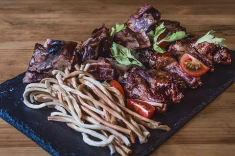 Assorted snacks for beer in the bar. Meat, cheese, onion rings on the grill a Foto stock