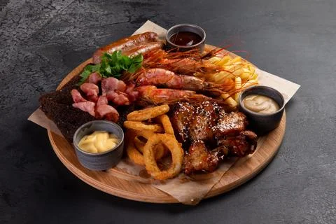 Assorted snacks for beer on a dark background. selective focus. Stock Photos