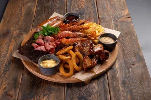 Assorted snacks for beer on a wooden background. selective focus. Stock Photos