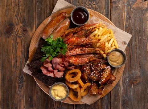 Assorted snacks for beer on a wooden background. selective focus. Stock Photos
