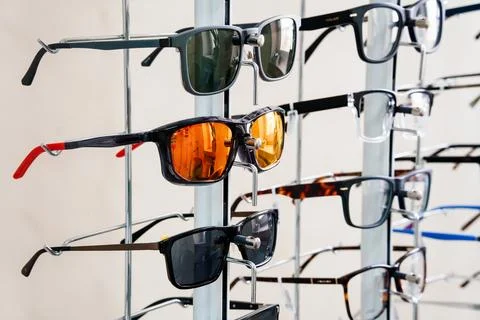 Assorted Spectacles Display Stand In Optometry Store Interior With White Wa.. Stock Photos