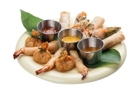 Assorted spring rolls on a white background. Stock Photos