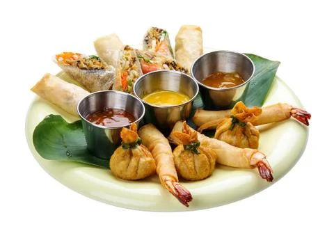 Assorted spring rolls on a white background. Stock Photos