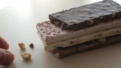 Assorted Stack of Nougat and Chocolate Bars with Nutty Accents Stock Footage 321790251
