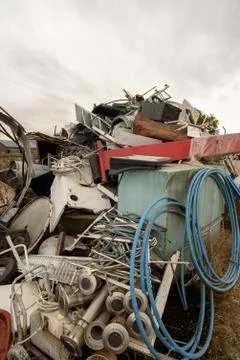 Assorted stack of scrap metal and household appliances for recycling at a mer Stock Photos