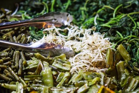 Assorted Steam Boiled Vegetables Pecel Ingredients with Metal Tongs Fotos Stock