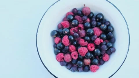 Assorted summer berries in a bowl on white background with copy space. Stock Footage 202010695