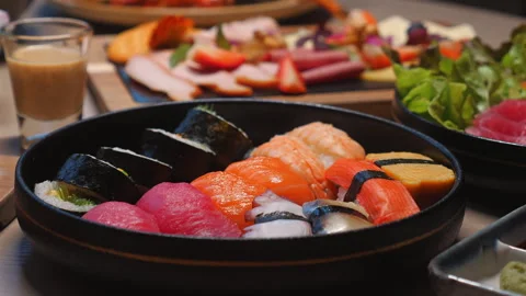 Assorted sushi platter with fresh salmon, tuna, and nigiri rolls Stock Footage 281276338