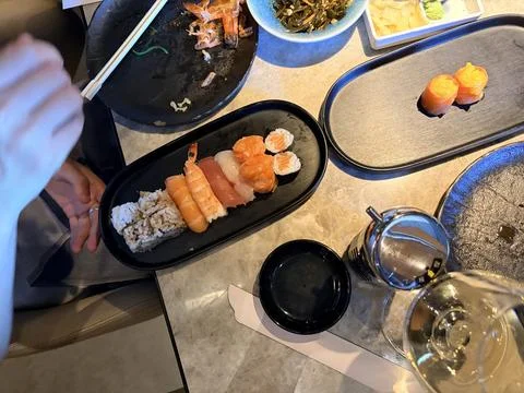 Assorted Sushi Platter with Soy Sauce and Chopsticks on Restaurant Table 스톡 사진