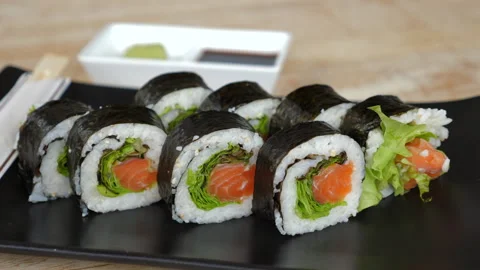 Assorted sushi rolls featuring fresh salmon, crisp lettuce, and Stock Footage 275613812