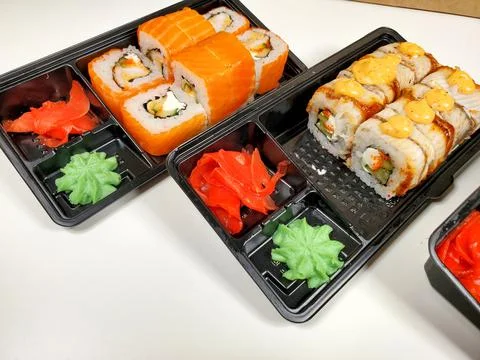 Assorted sushi rolls on an isolated white background. Delivery of Japanese Stock Photos