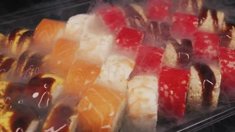 Assorted Sushi Rolls Platter Covered In Cold Dry Ice Smoke Video stock 329681532