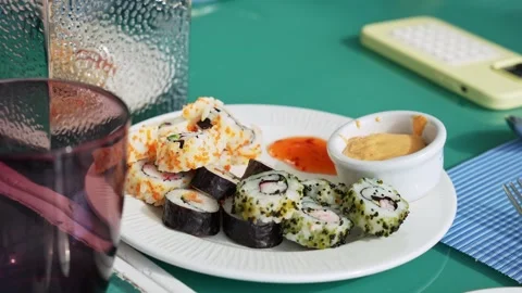 Assorted Sushi Rolls With Sauces On Dining Table 库存影片 336643540