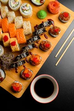 Assorted sushi set on dark background. Japanese rolls, soy sauce, ginger Stock-Fotos