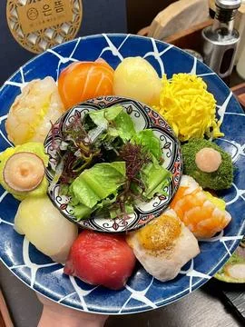 Assorted sushi set, featuring a variety of traditional Japanese dishes. Per.. Stock Photos