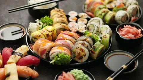 Assorted sushi set served on dark dark background. Top view of seafood, various Stock Footage 138461511