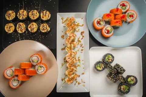 Assorted Sushi Set Variety on Multiple Plates Overview Stock Photos