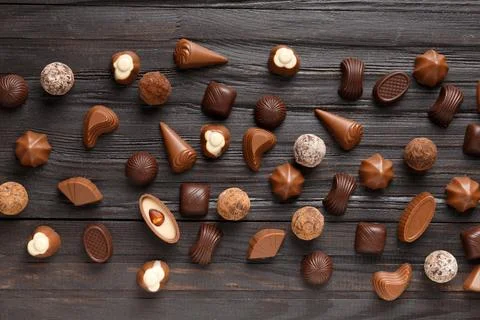 Assorted sweets, chocolate truffles on a dark wooden background top view Stock Photos