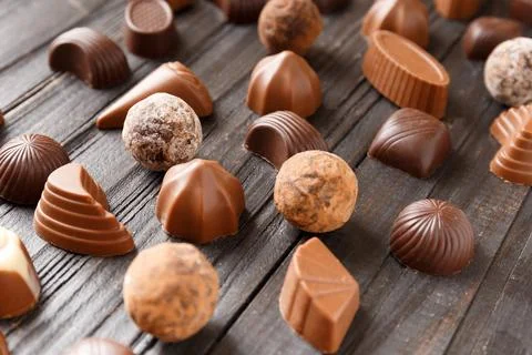 Assorted sweets, chocolate truffles on a dark wooden background Stock Photos
