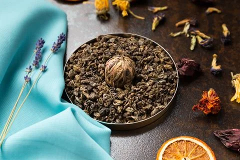 Assorted tea and citrus chips on a dark background. Stock Photos