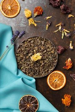 Assorted tea and citrus chips on a dark background top view. Stock Photos