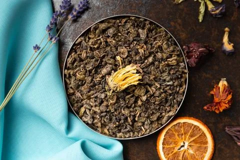 Assorted tea and citrus chips on a dark background top view. Stock Photos