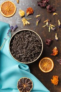 Assorted tea and citrus chips on a dark background top view. Stock Photos