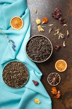 Assorted tea and citrus chips on a dark background top view. Stock Photos