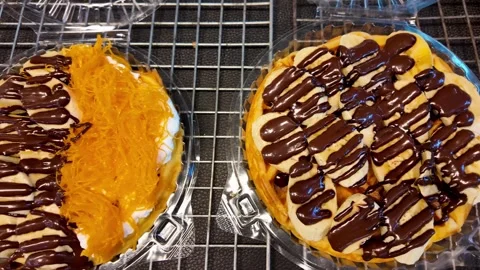 Assorted Thai Dessert Cakes with Chocolate Drizzle on Display Video stock 335998751