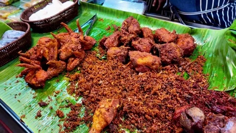 Assorted Thai Fried Chicken and Crispy Street Food Display on Banana Leaves Video stock 336390021