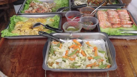 Assorted Thai seafood buffet with grilled shrimp, stir-fried vegetables, sq.. Video stock 342385300