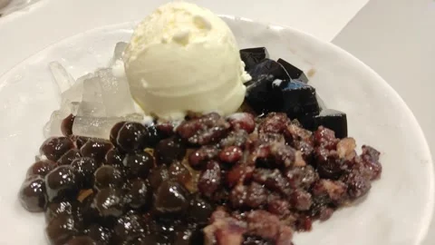 Assorted topping on ice shaving and ice cream Stock Footage 263573708