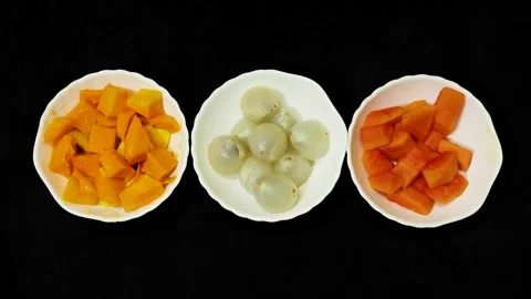 Assorted tropical fruit bowls with mango lychee and papaya on black backgro.. Stock Footage 336646210