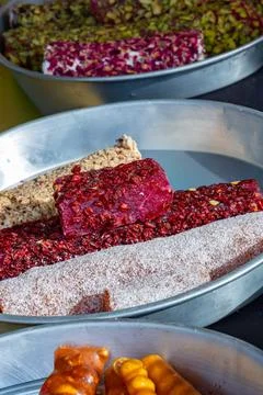 Assorted Turkish Delight Rolls With Berries And Coconut In Metal Trays Stock Photos