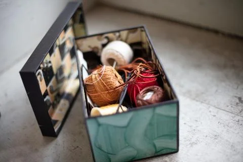 Assorted twines,   string and thread rolls in an open box Stock Photos