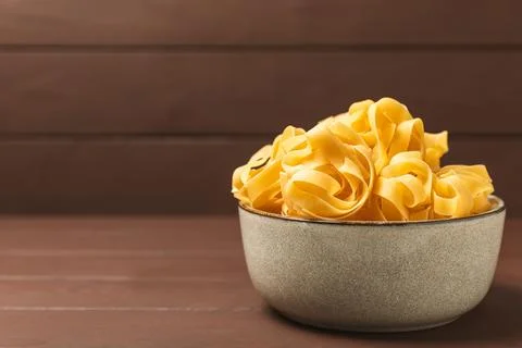 Assorted uncooked pasta in bowls Stock Photos