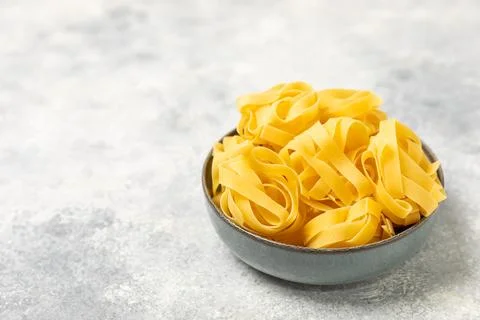 Assorted uncooked pasta in bowls Stock Photos