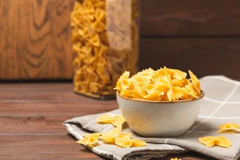 Assorted uncooked pasta in bowls Stock Photos