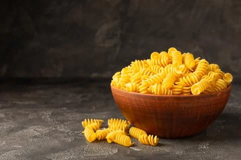 Assorted uncooked pasta in bowls Stock Photos