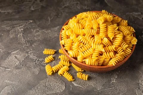 Assorted uncooked pasta in bowls Stock Photos