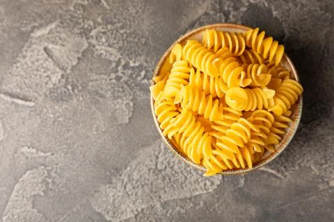 Assorted uncooked pasta in bowls Stock Photos