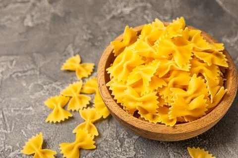 Assorted uncooked pasta in bowls Stock Photos