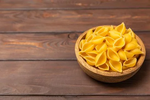 Assorted uncooked pasta in bowls. Stock Photos