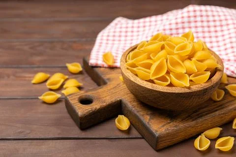 Assorted uncooked pasta in bowls. Stock Photos