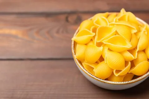 Assorted uncooked pasta in bowls. Stock Photos