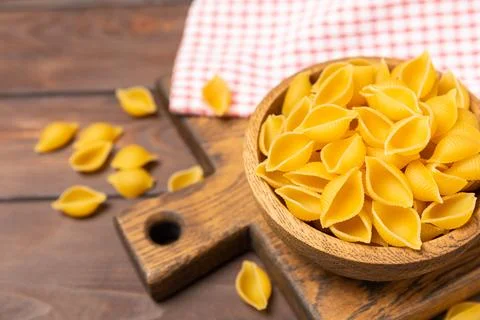 Assorted uncooked pasta in bowls. Stock Photos