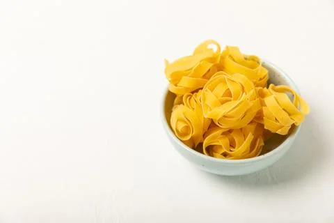 Assorted uncooked pasta in bowls. Stock Photos