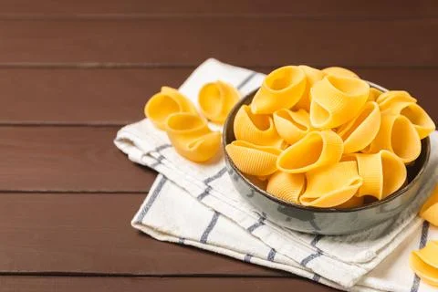 Assorted uncooked pasta in bowls. Stock Photos
