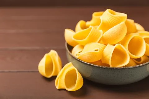 Assorted uncooked pasta in bowls. Stock Photos
